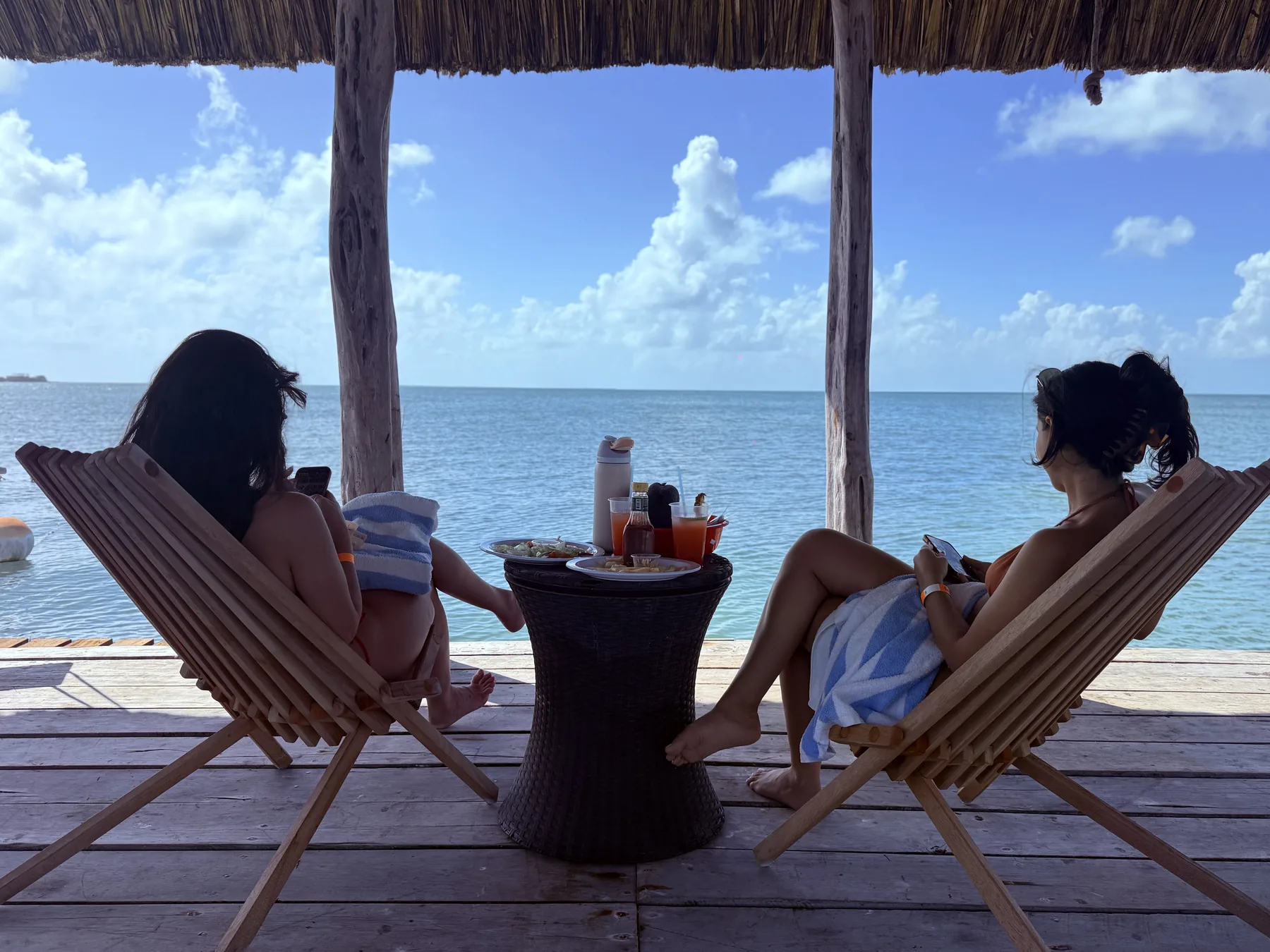 Guests relaxing by the sea at Bounty Bay